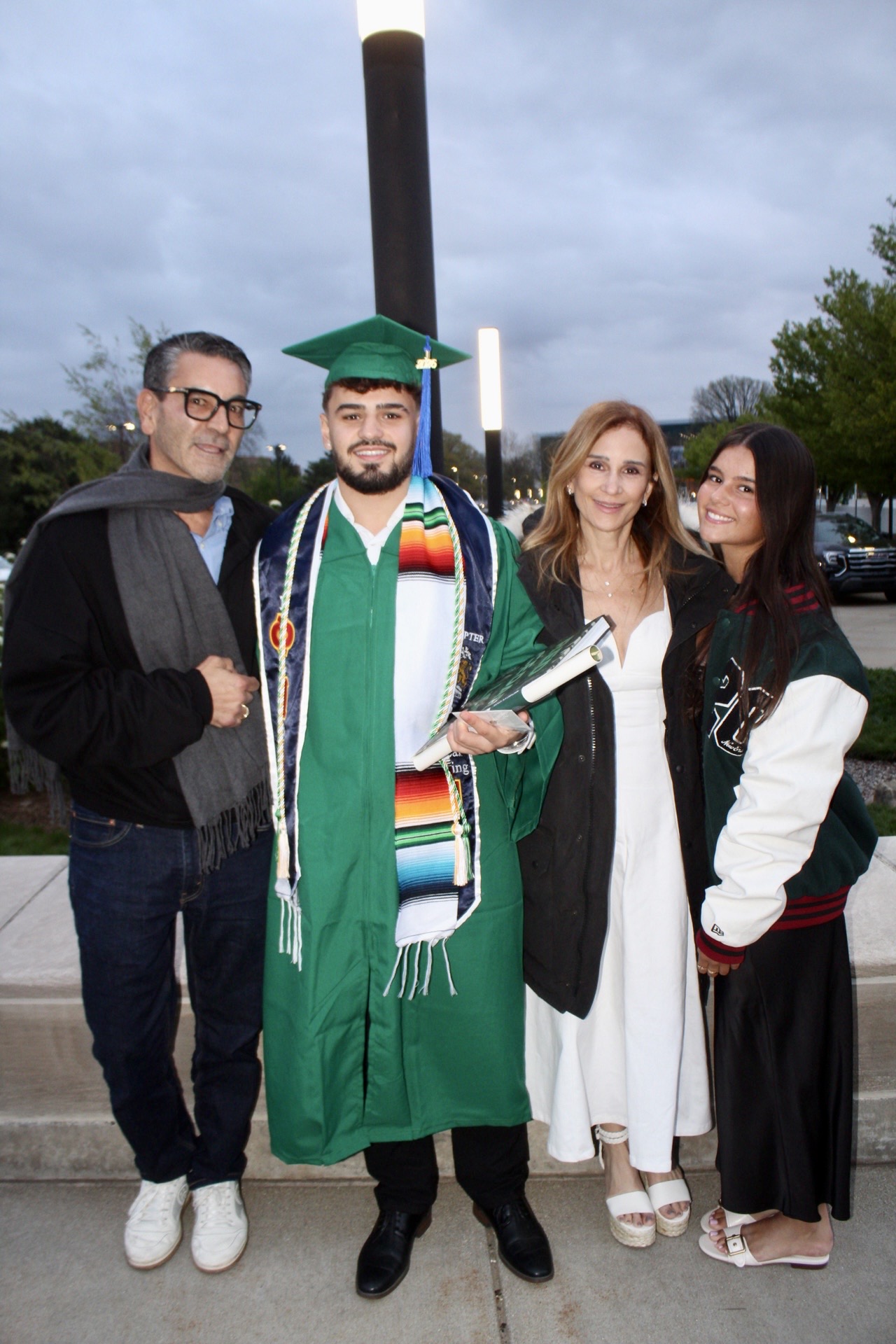 Graduate celebrating with family after commencement