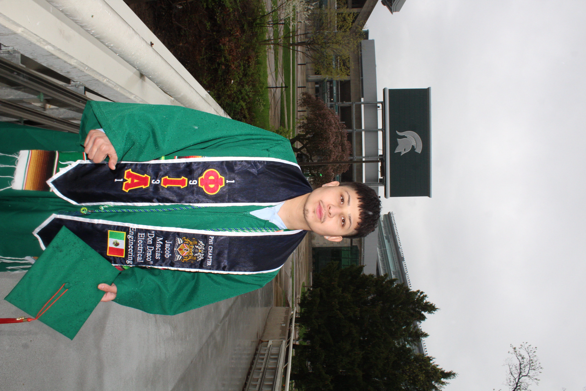 First-generation graduate portrait with the Spartan Stadium sign